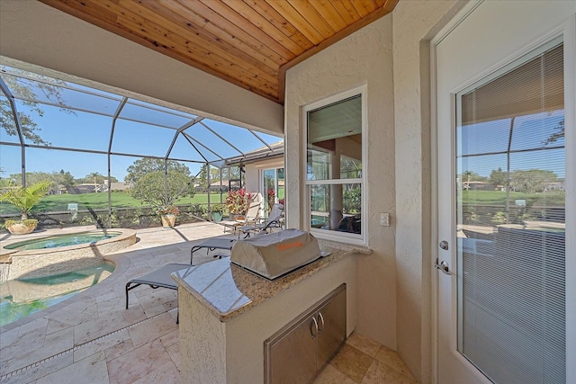 view of patio featuring exterior kitchen, an in ground hot tub, a lanai, and a grill