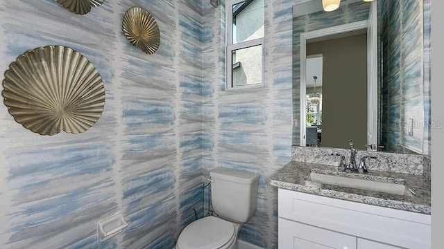 bathroom featuring vanity and toilet