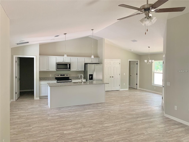 kitchen featuring hanging light fixtures, white cabinetry, appliances with stainless steel finishes, and a center island with sink