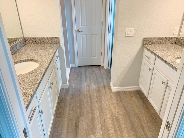 bathroom featuring vanity and hardwood / wood-style floors