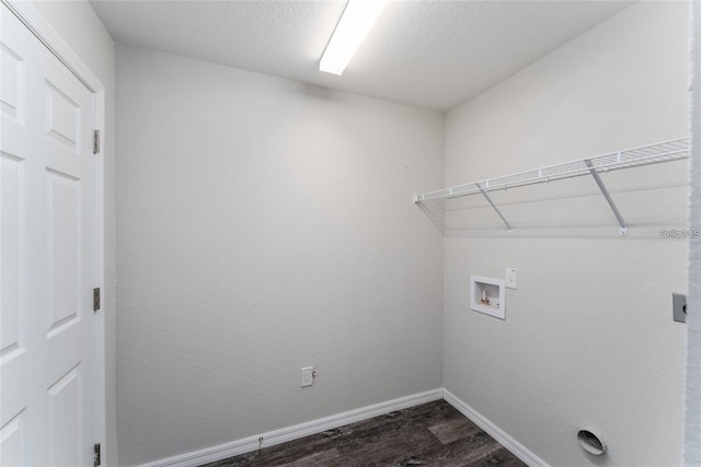 laundry area with dark hardwood / wood-style flooring, washer hookup, and a textured ceiling