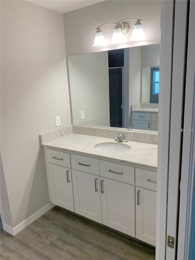 bathroom with vanity and hardwood / wood-style floors