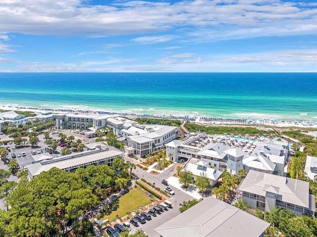 drone / aerial view featuring a beach view and a water view