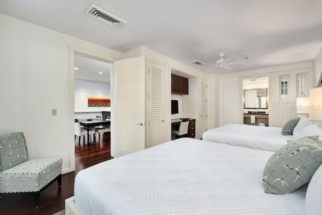 bedroom with dark hardwood / wood-style flooring and ceiling fan