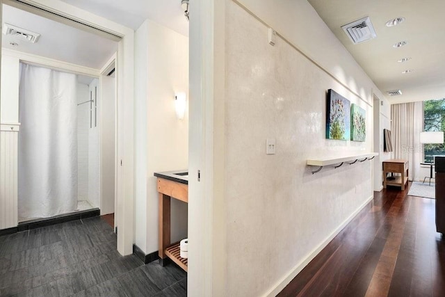 hallway with dark hardwood / wood-style flooring