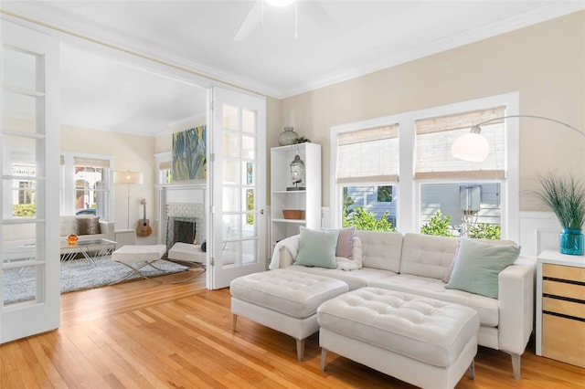 interior space featuring a fireplace, crown molding, and wood-type flooring