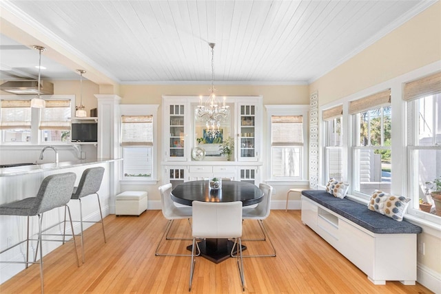 dining room with ornamental molding, a notable chandelier, light wood-type flooring, and wood ceiling