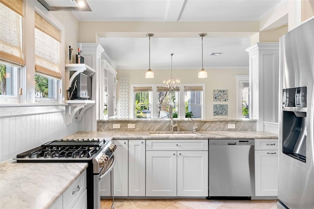 kitchen with white cabinetry, sink, stainless steel appliances, and light stone countertops