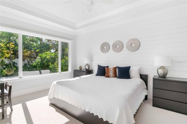 bedroom featuring ornamental molding, light carpet, and ceiling fan