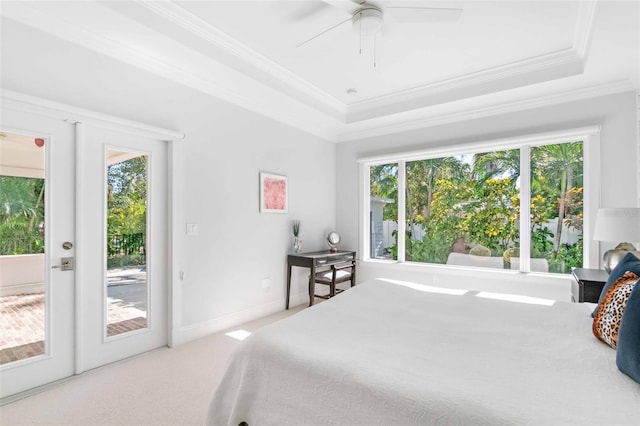 carpeted bedroom featuring french doors, a tray ceiling, access to exterior, and crown molding