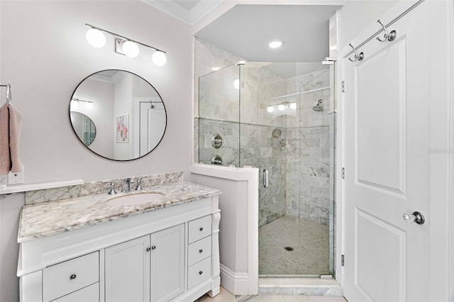 bathroom with crown molding, vanity, and an enclosed shower