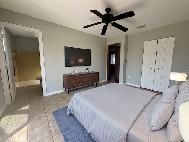 bedroom featuring connected bathroom, light tile patterned floors, a closet, and ceiling fan