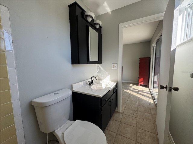 bathroom with vanity, tile patterned flooring, and toilet