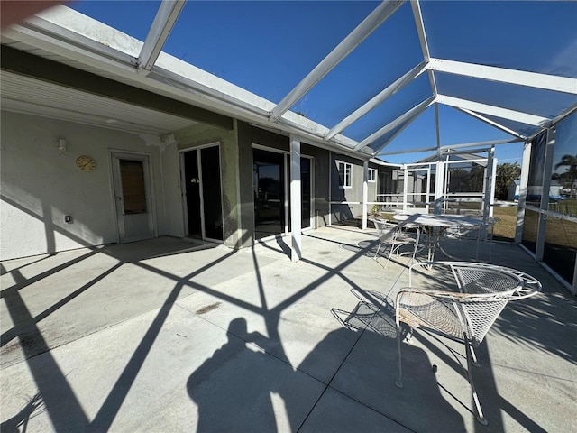 view of patio featuring a lanai