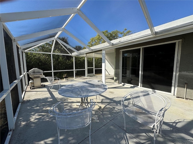 view of patio / terrace with grilling area and glass enclosure