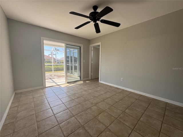 unfurnished room with tile patterned flooring, baseboards, and a ceiling fan