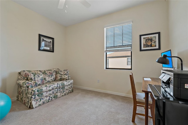 carpeted office space featuring ceiling fan