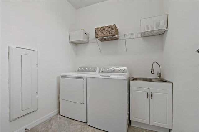 laundry area featuring cabinets, sink, and washing machine and dryer