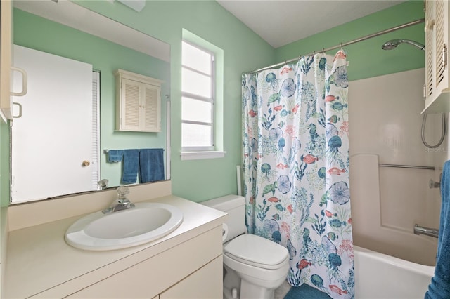 full bathroom featuring toilet, vanity, and shower / bathtub combination with curtain