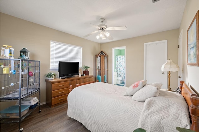 bedroom featuring dark wood-type flooring, ceiling fan, and ensuite bath