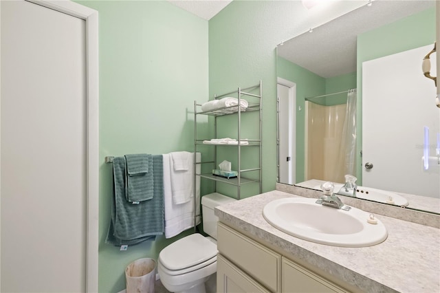 bathroom with vanity, curtained shower, and toilet