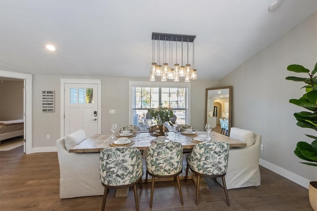 dining area with dark hardwood / wood-style flooring and lofted ceiling