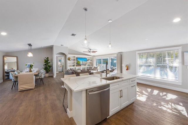 kitchen featuring white cabinetry, hanging light fixtures, light stone countertops, a center island with sink, and stainless steel dishwasher