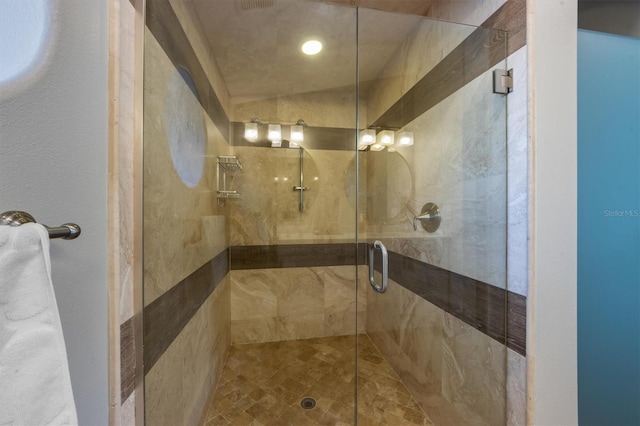 bathroom featuring a shower with shower door