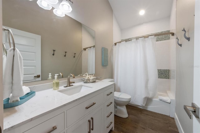 full bathroom with vanity, hardwood / wood-style floors, toilet, and shower / bathtub combination with curtain