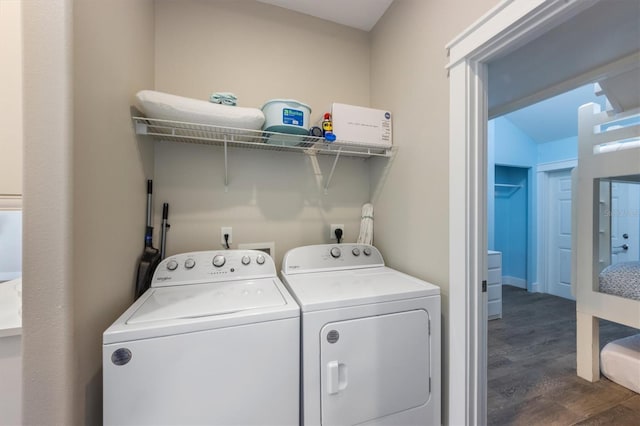 washroom featuring dark hardwood / wood-style flooring and washer and clothes dryer