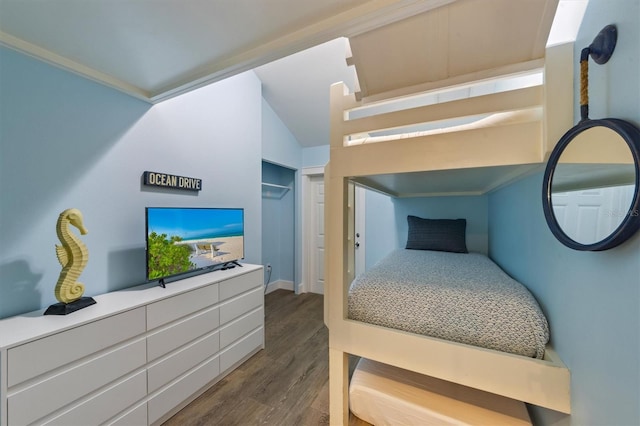 bedroom with dark wood-type flooring and vaulted ceiling