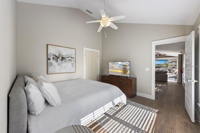 bedroom featuring lofted ceiling, dark wood-type flooring, a closet, and ceiling fan