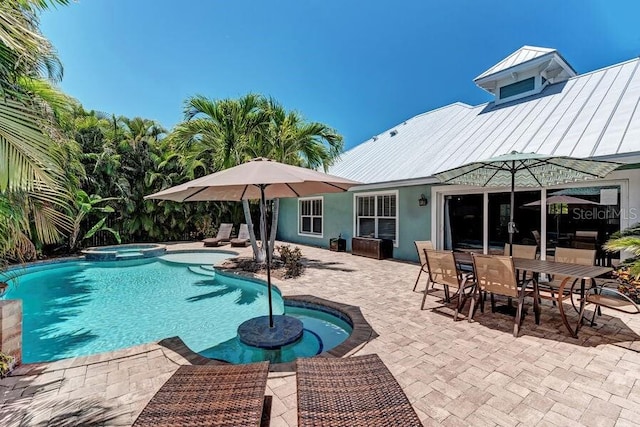 view of swimming pool featuring an in ground hot tub and a patio area