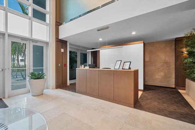 kitchen with hanging light fixtures and a high ceiling