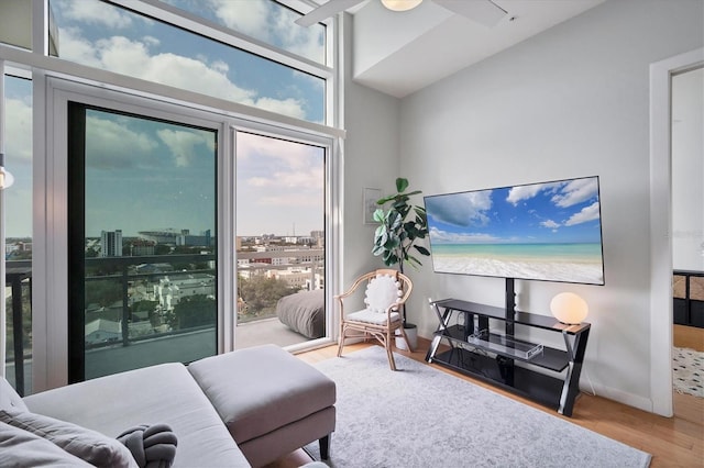 living room featuring lofted ceiling and light hardwood / wood-style flooring