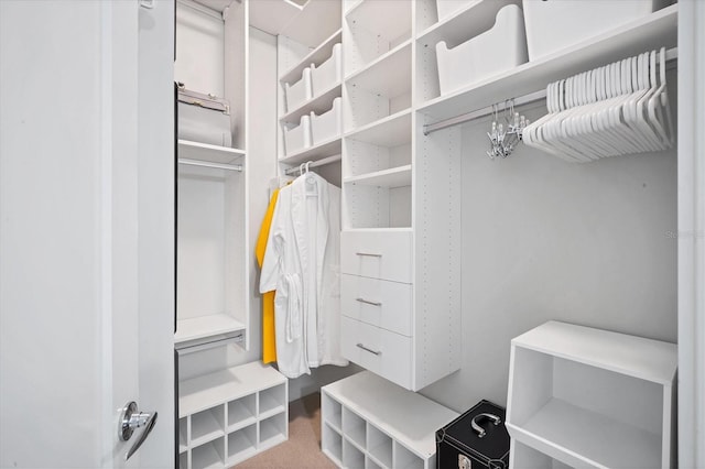 spacious closet with a notable chandelier