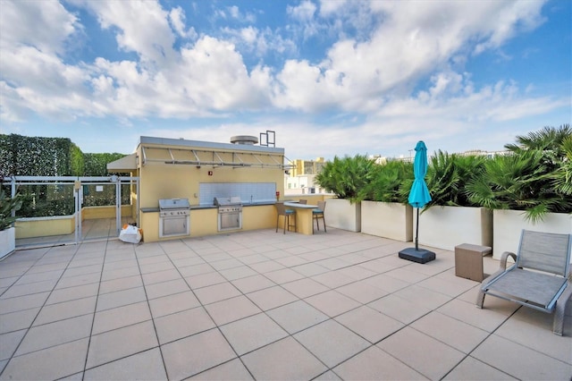 view of patio featuring area for grilling and a grill