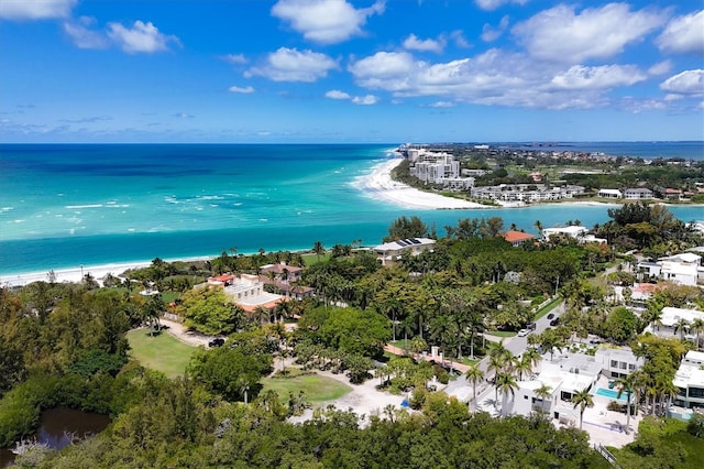 birds eye view of property with a water view and a view of the beach