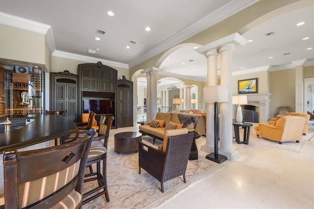 living room featuring decorative columns and ornamental molding