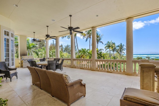 view of patio / terrace featuring a water view, area for grilling, and ceiling fan