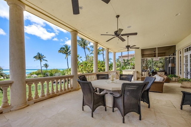 view of patio / terrace with a water view and ceiling fan