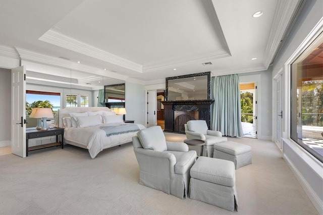 carpeted bedroom featuring crown molding, access to exterior, and a tray ceiling