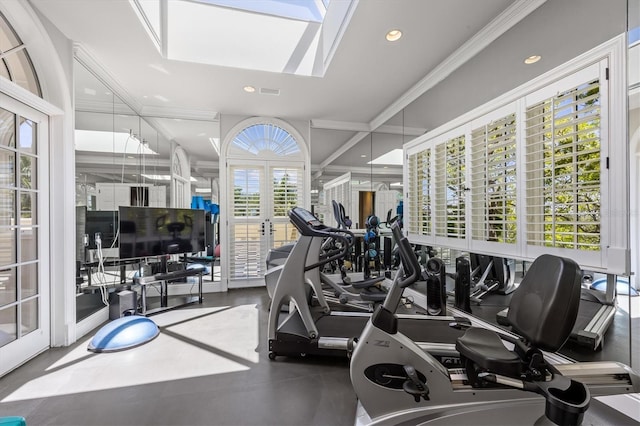 exercise room featuring a skylight, ornamental molding, and french doors