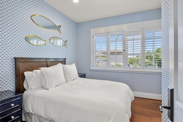 bedroom with dark hardwood / wood-style flooring