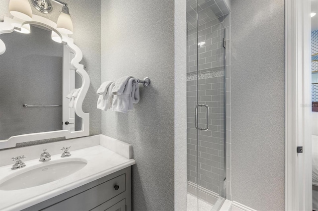 bathroom featuring walk in shower and vanity