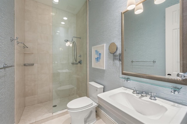 bathroom featuring sink, tiled shower, tile walls, and toilet