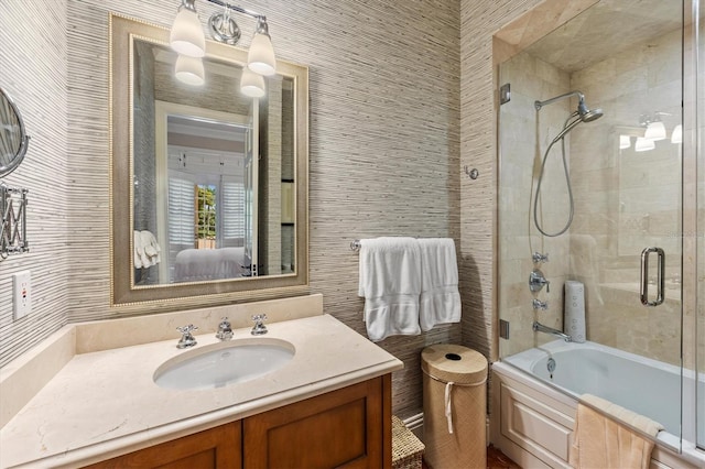 bathroom featuring enclosed tub / shower combo, tile walls, and vanity