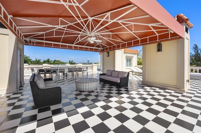 view of patio / terrace with exterior bar, an outdoor hangout area, and ceiling fan