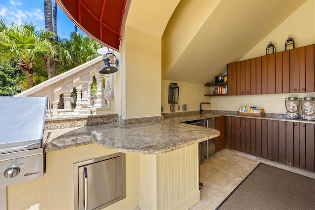 kitchen featuring vaulted ceiling and kitchen peninsula