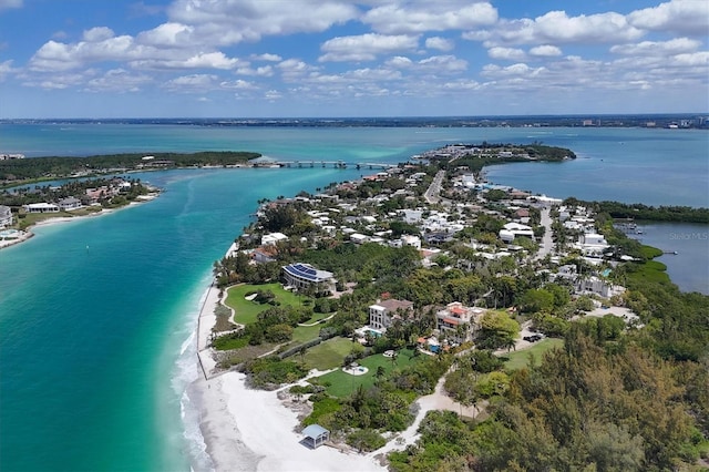 birds eye view of property featuring a water view and a beach view